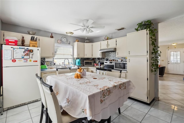 kitchen with cream cabinets, stainless steel appliances, a healthy amount of sunlight, and ceiling fan