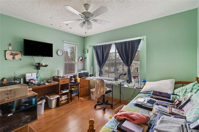 office space featuring ceiling fan, wood-type flooring, and a textured ceiling