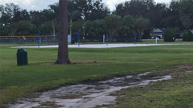 view of home's community featuring a lawn and volleyball court