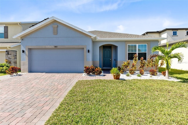 view of front of house featuring a garage and a front yard