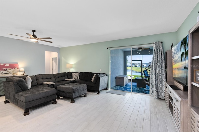 living room with ceiling fan and light hardwood / wood-style flooring