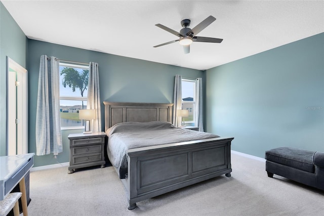 bedroom with ceiling fan and light colored carpet