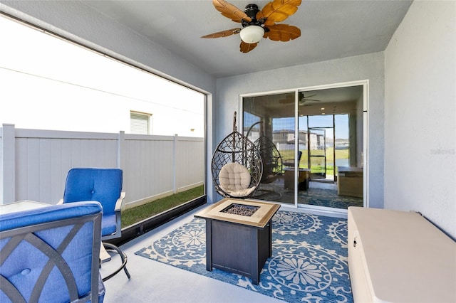 view of patio featuring a fire pit and ceiling fan