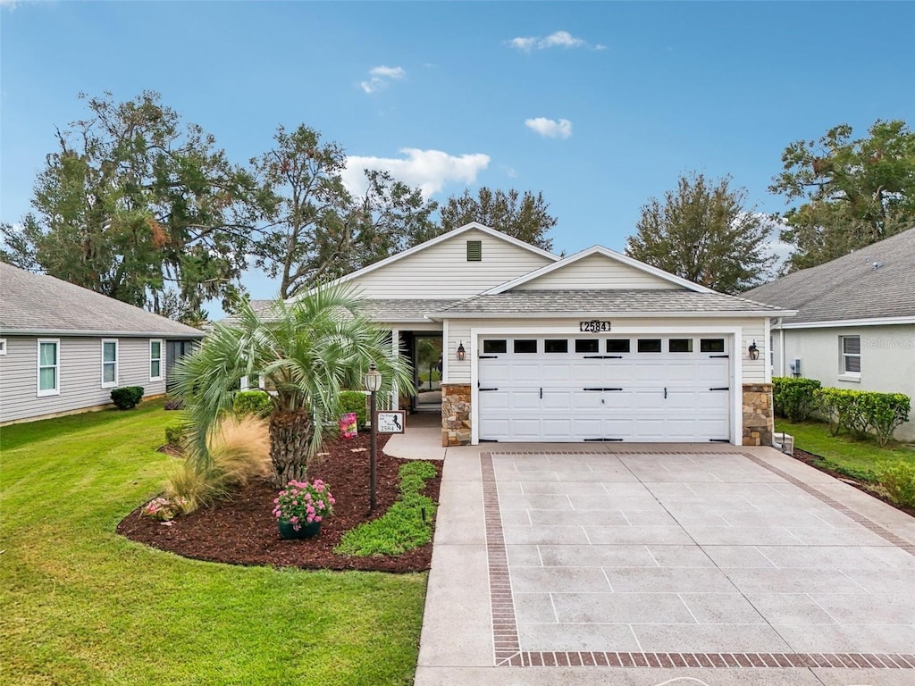 single story home with a garage and a front lawn