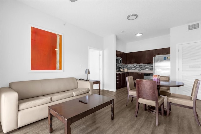 living room featuring sink and hardwood / wood-style floors