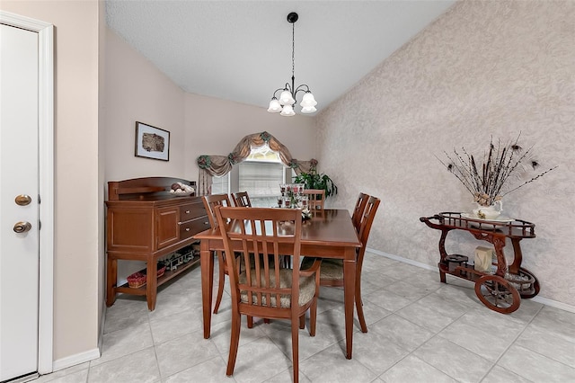 tiled dining space featuring a notable chandelier and a textured ceiling