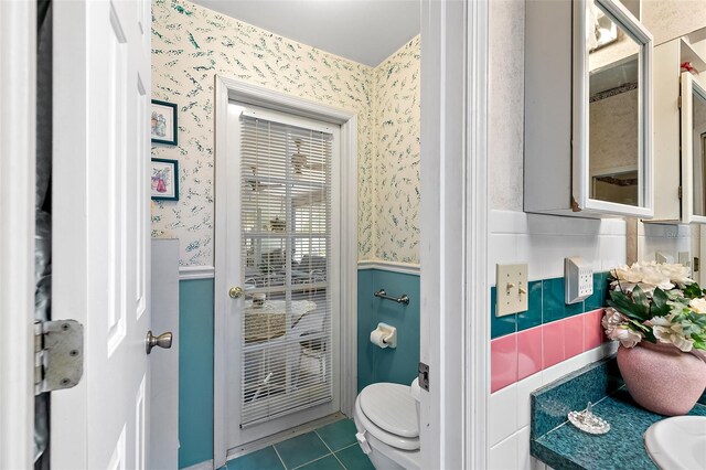 bathroom featuring toilet and tile patterned flooring