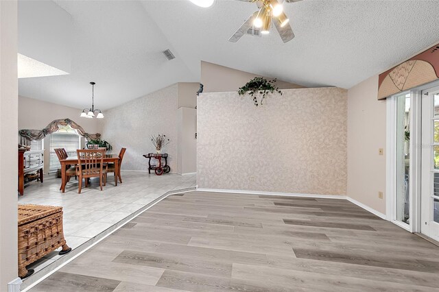 unfurnished dining area featuring lofted ceiling, hardwood / wood-style flooring, and plenty of natural light