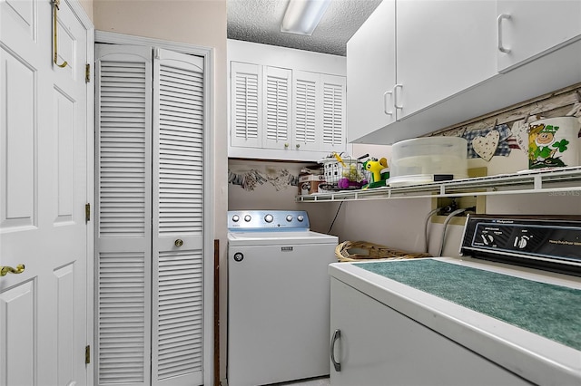 clothes washing area featuring independent washer and dryer, a textured ceiling, and cabinets