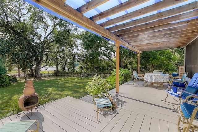 deck with a pergola and a lawn