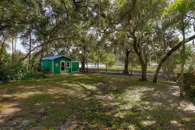 view of yard with an outdoor structure and a water view