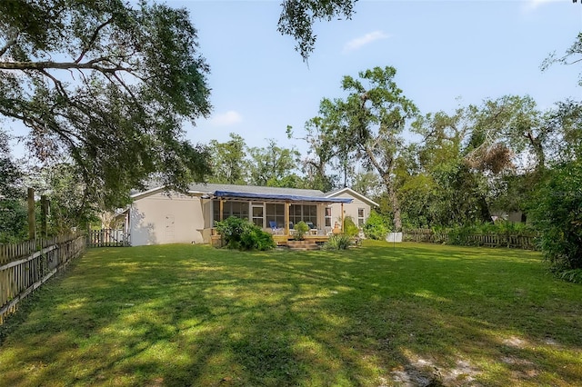 rear view of property featuring a lawn