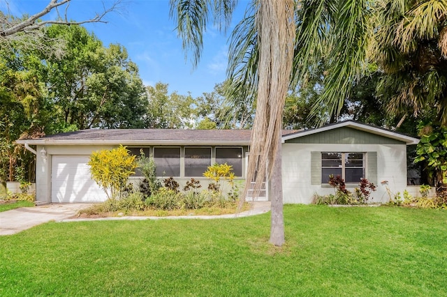 single story home with a garage and a front lawn