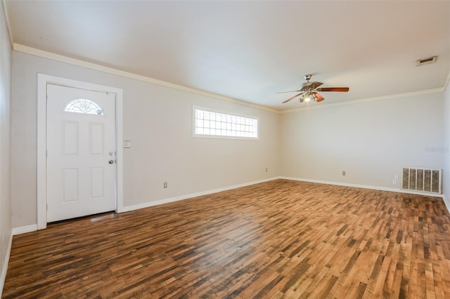 entrance foyer with crown molding, dark wood-type flooring, and a wealth of natural light