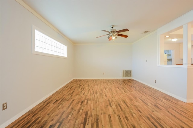 empty room featuring ornamental molding, wood-type flooring, and ceiling fan