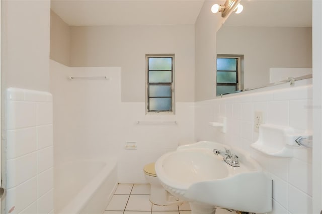 full bathroom featuring sink, toilet, shower / bath combination, tile patterned floors, and tile walls