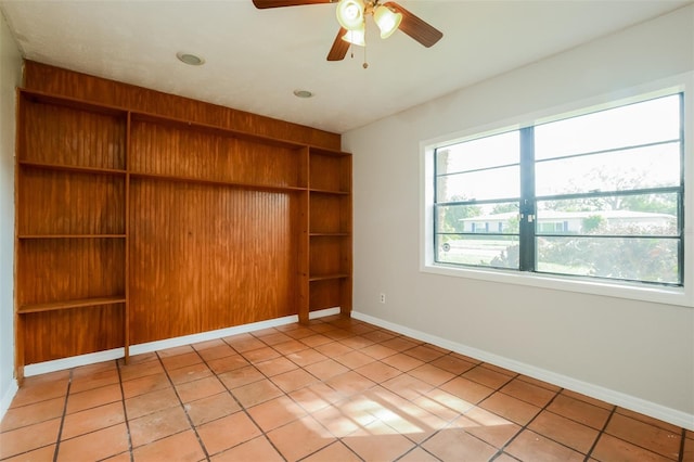 spare room featuring light tile patterned flooring and ceiling fan