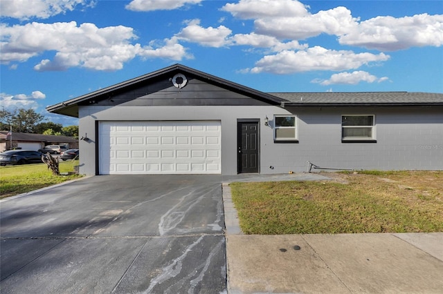 ranch-style house with a front yard and a garage