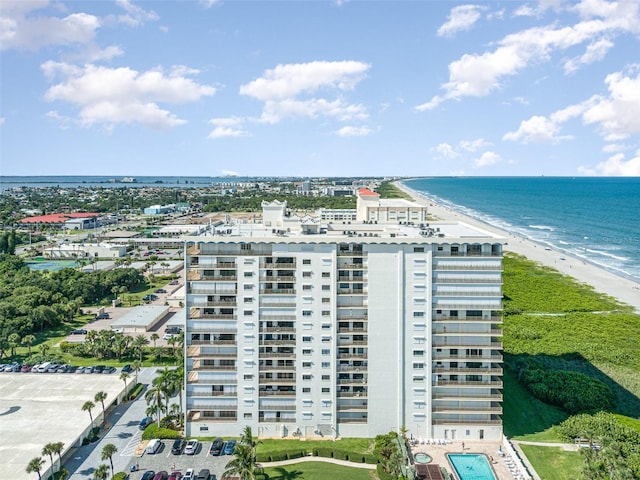 bird's eye view featuring a water view and a view of the beach