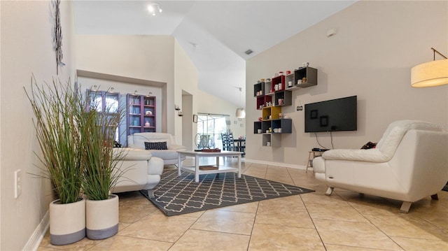 living room with light tile patterned flooring and high vaulted ceiling