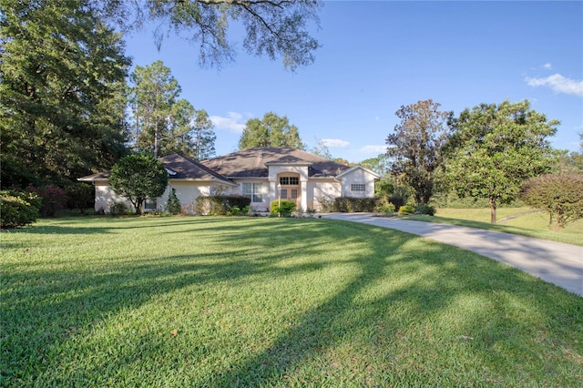 ranch-style home featuring a front yard