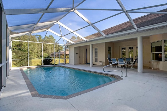 view of pool with a patio area and a lanai