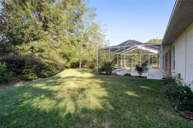 view of yard with glass enclosure