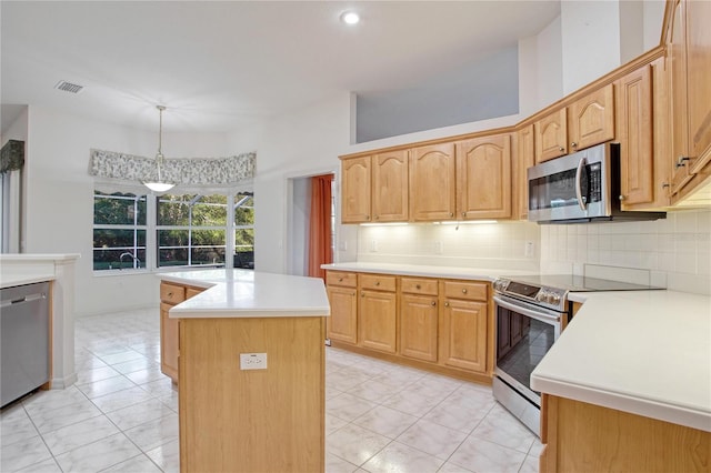 kitchen with a kitchen island, backsplash, pendant lighting, light tile patterned floors, and appliances with stainless steel finishes