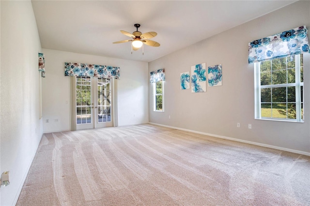 unfurnished room with french doors, ceiling fan, and light colored carpet