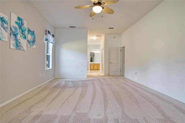 carpeted spare room with ceiling fan