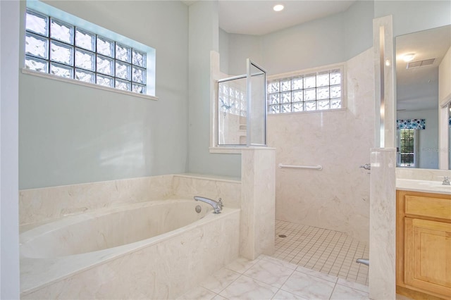 bathroom with vanity, a healthy amount of sunlight, and separate shower and tub