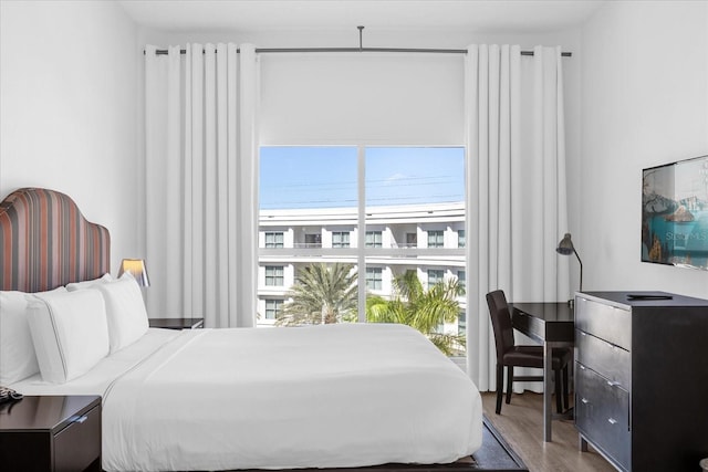 bedroom featuring multiple windows and hardwood / wood-style flooring