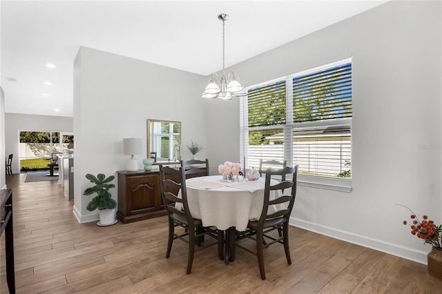 dining room with an inviting chandelier and light wood-type flooring