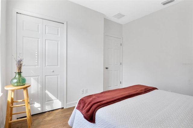 bedroom featuring wood-type flooring and a closet