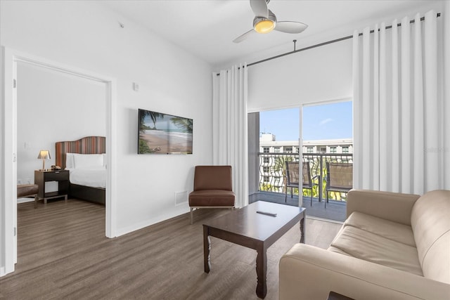 living room featuring wood-type flooring and ceiling fan