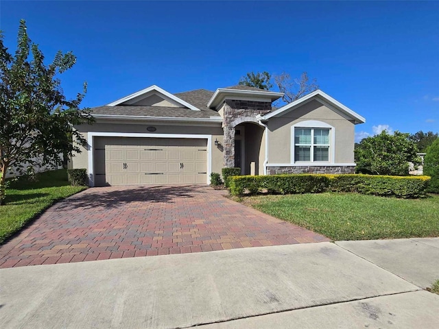 single story home featuring a garage and a front lawn