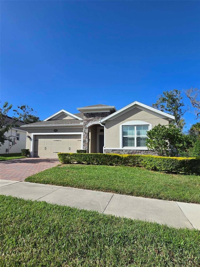 view of front of property with a garage and a front lawn