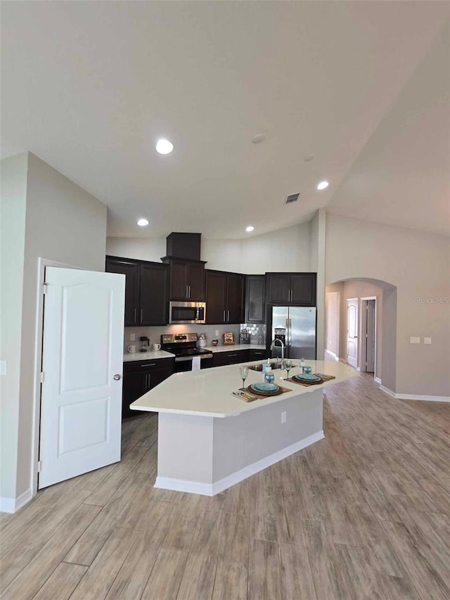 kitchen featuring a kitchen island with sink, light hardwood / wood-style flooring, stainless steel appliances, and sink