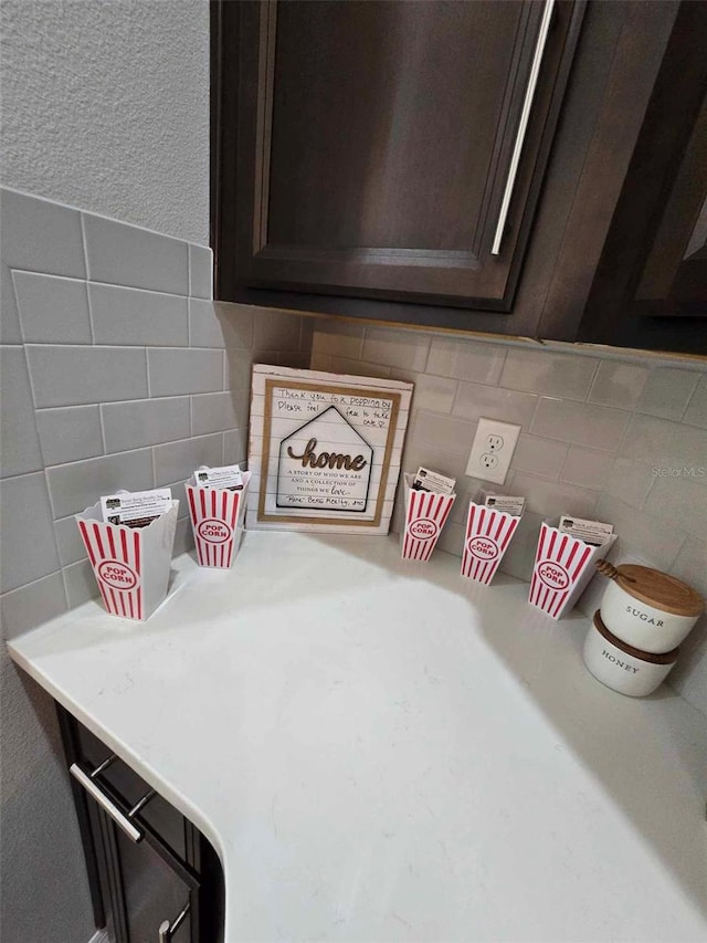 details with dark brown cabinets and decorative backsplash