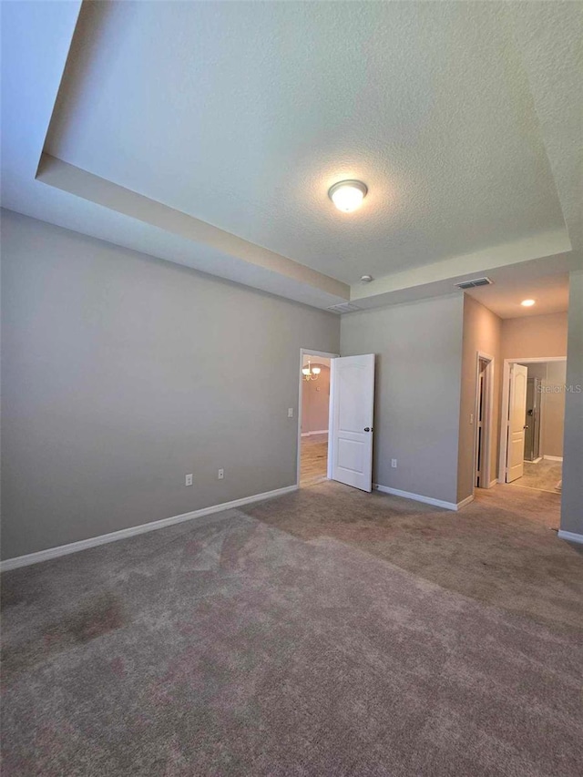 empty room featuring carpet flooring and a textured ceiling