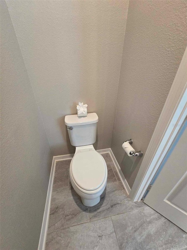 bathroom featuring tile patterned flooring and toilet