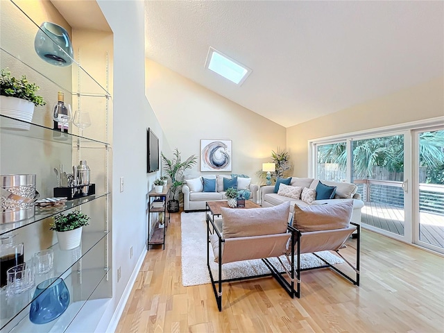 living room featuring high vaulted ceiling and light wood-type flooring