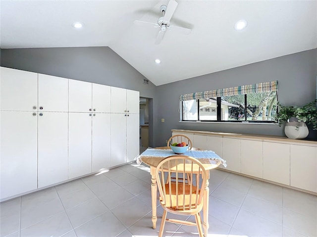 unfurnished dining area with lofted ceiling, light tile patterned floors, and ceiling fan