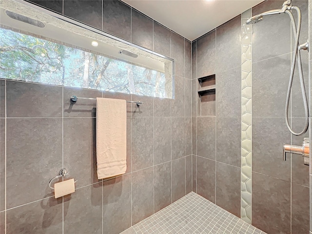 bathroom with tiled shower