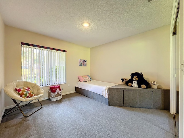 bedroom with a textured ceiling and carpet flooring