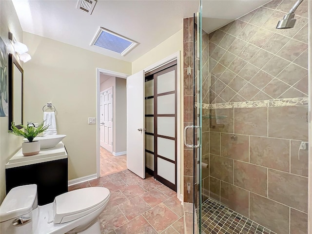 bathroom with vanity, toilet, and a shower with shower door