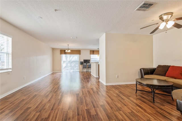 living room featuring ceiling fan, a textured ceiling, and hardwood / wood-style floors