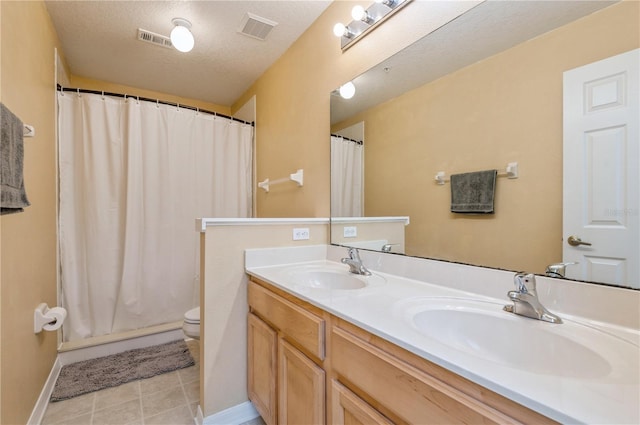 bathroom featuring tile patterned floors, toilet, curtained shower, vanity, and a textured ceiling