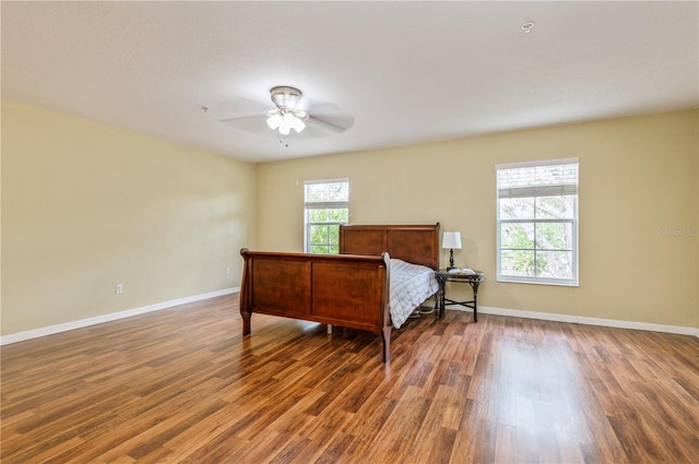 bedroom with ceiling fan and dark hardwood / wood-style flooring