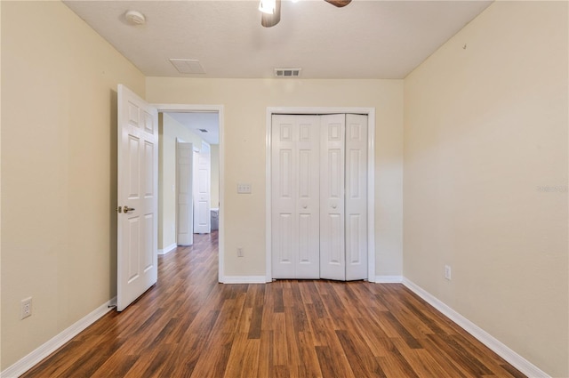 unfurnished bedroom featuring a closet, ceiling fan, and dark hardwood / wood-style flooring